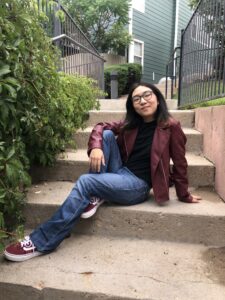 Kass Bat-Itgel sitting on a staircase outdoors